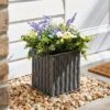Artificial Floral Arrangement In Grey Trough
