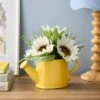 Artificial Daisies In A Yellow Watering Can