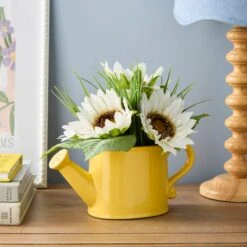 Artificial Daisies In A Yellow Watering Can